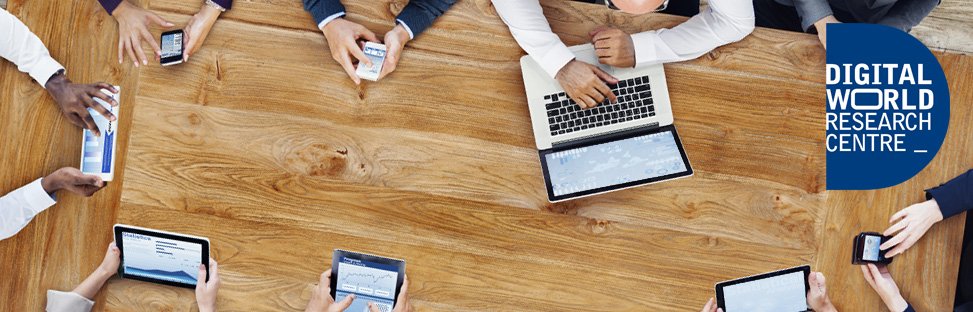 View from above of people using laptops, tablets and phones