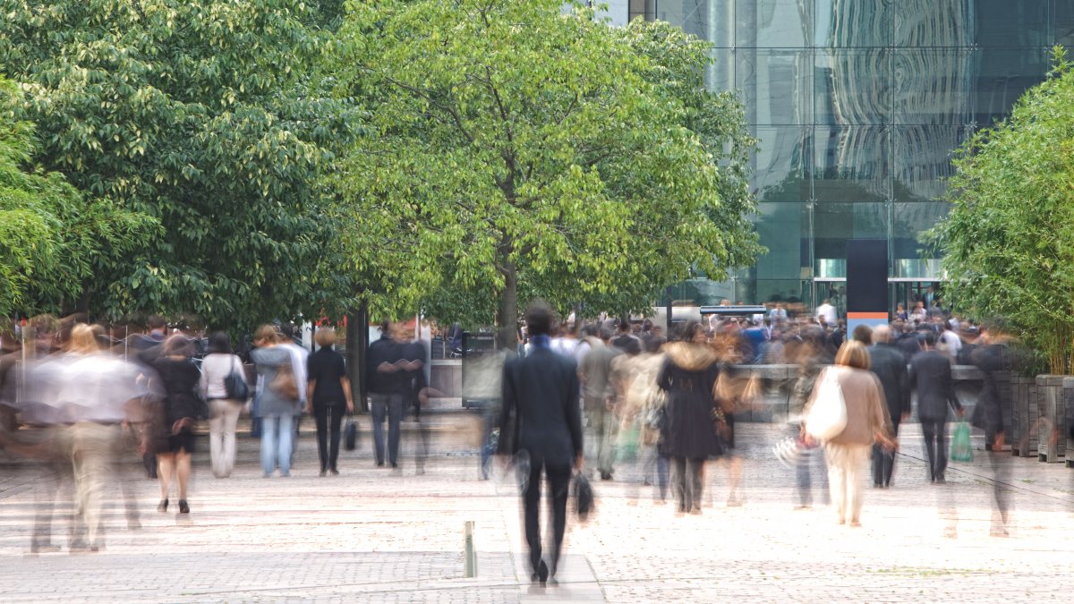 Crowd of people walking in city