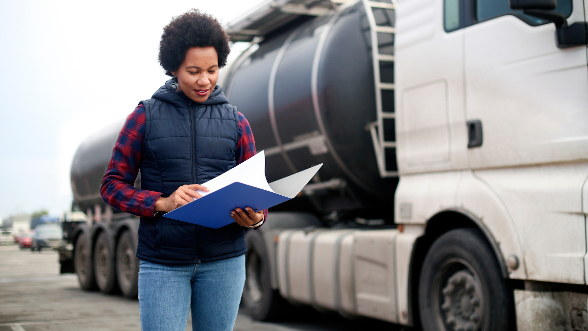 tanker driver checks papers beside HGV