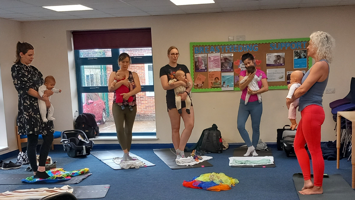 Women and babies taking part in yoga