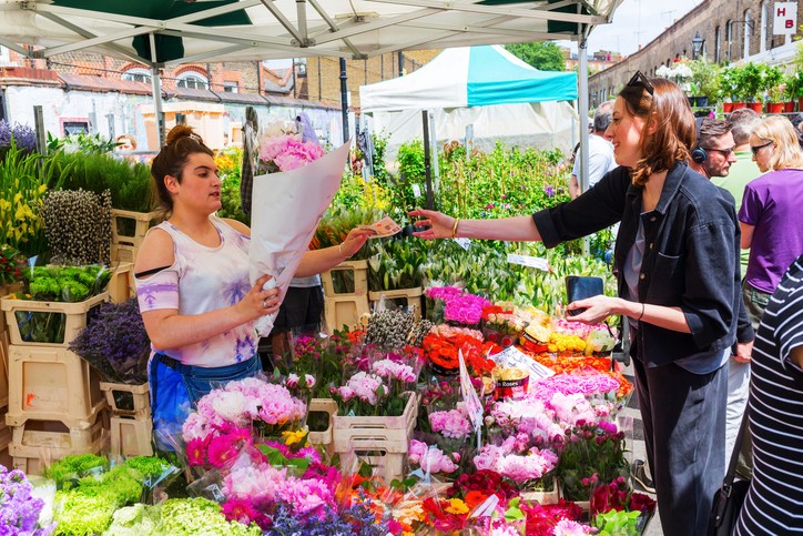 lady selling and woman buying flowers