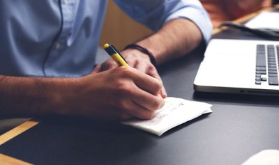 Man writing at a desk