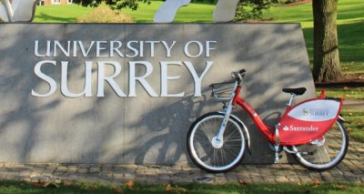 Bike resting about University of Surrey sign