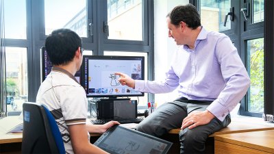 Two men looking at a computer screen