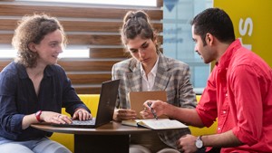 Students sat talking around a table in the MySurrey Hive