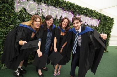 Image of students graduating and smiling