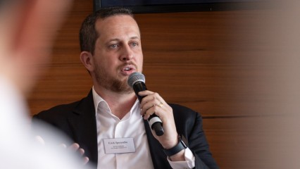 Dr Sperandio with microphone, talking at the conference, close up picture