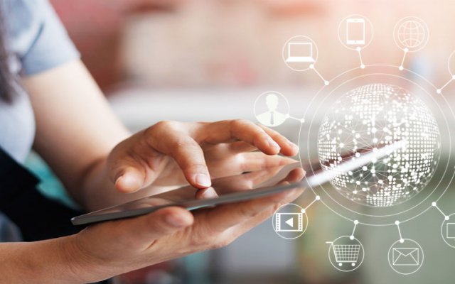 Woman using mobile with icons circling a globe