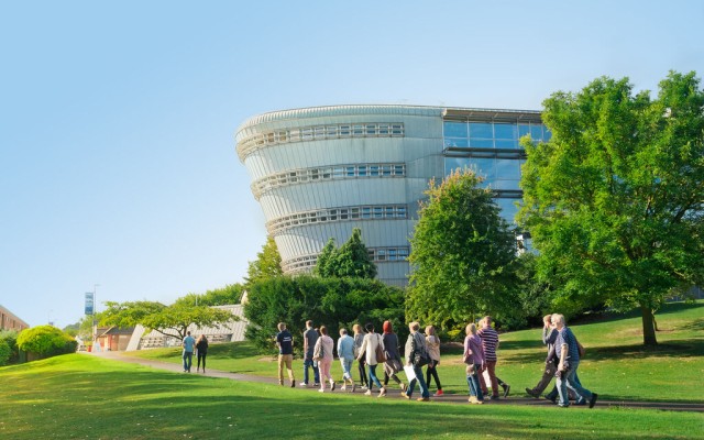 Group of prospective students walking past Duke of Kent Building on an Open Day