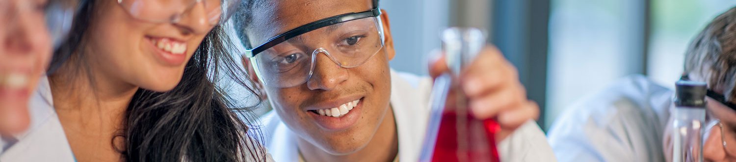 Students examining a conical falsk