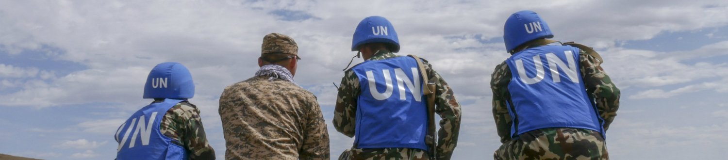 UN soldiers looking into distance.