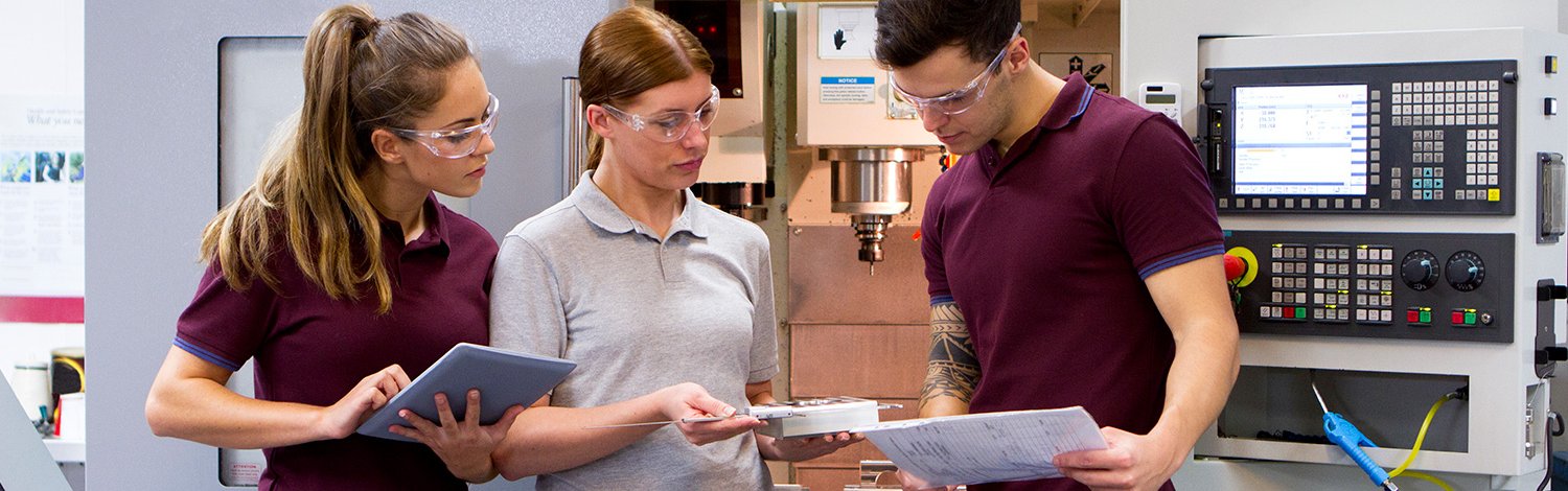 Students next to a CNC machine