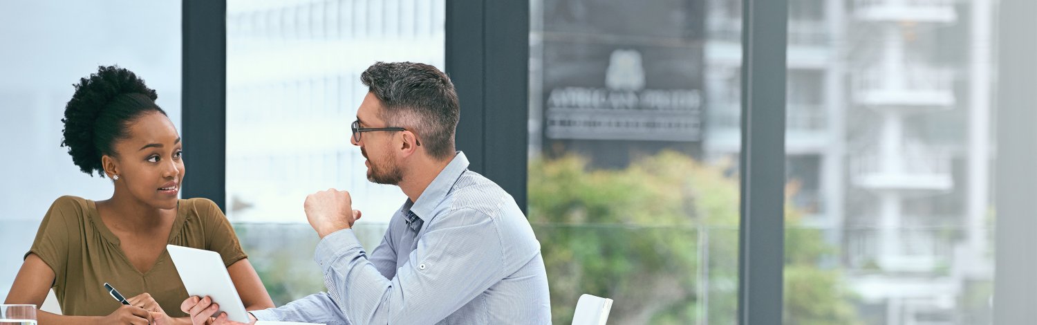 Male and female talking around table