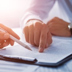 Hands pointing at clipboard