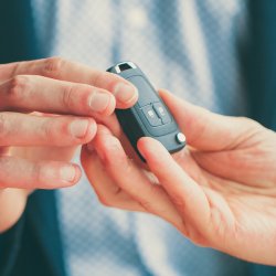 Key fob being passed from one person to another