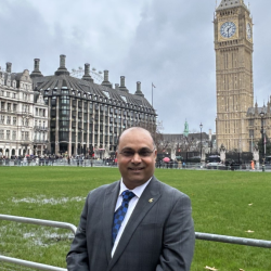 Professor Prashant Kumar stands in front of the Palace of Westminster, Parliament. 