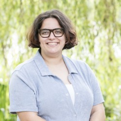 A person with brown hair and glasses. 