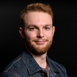 Image of a young, white man with blonde hair and a ginger beard.