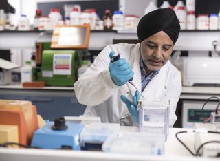 Hardev Pandha in the laboratory doing tests with tubes