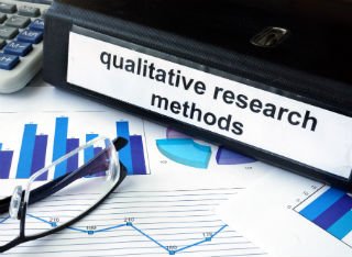 A desk with a Qualitative Research folder