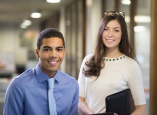 Two university students pictured in a modern office