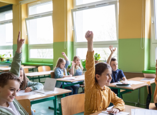 children in a classroom with open windows