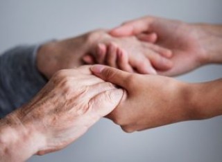 Younger hands helping and holding older person hands