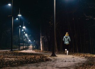 GettyImages - Woman running in a park at night