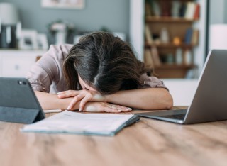 women stressed at work with head on desk