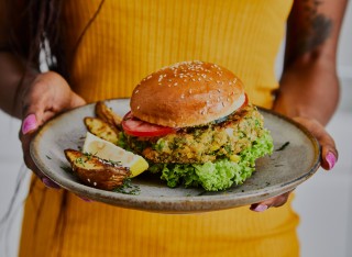 Person holds vegetarian burger