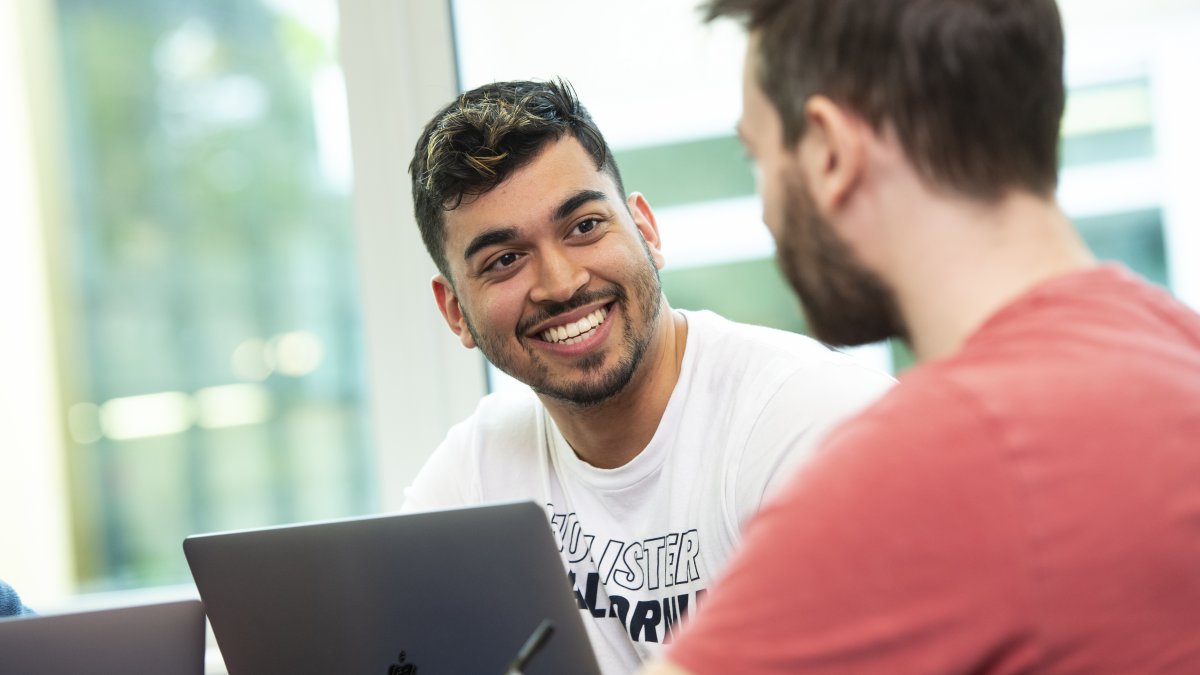 Smiling postgraduate male students 