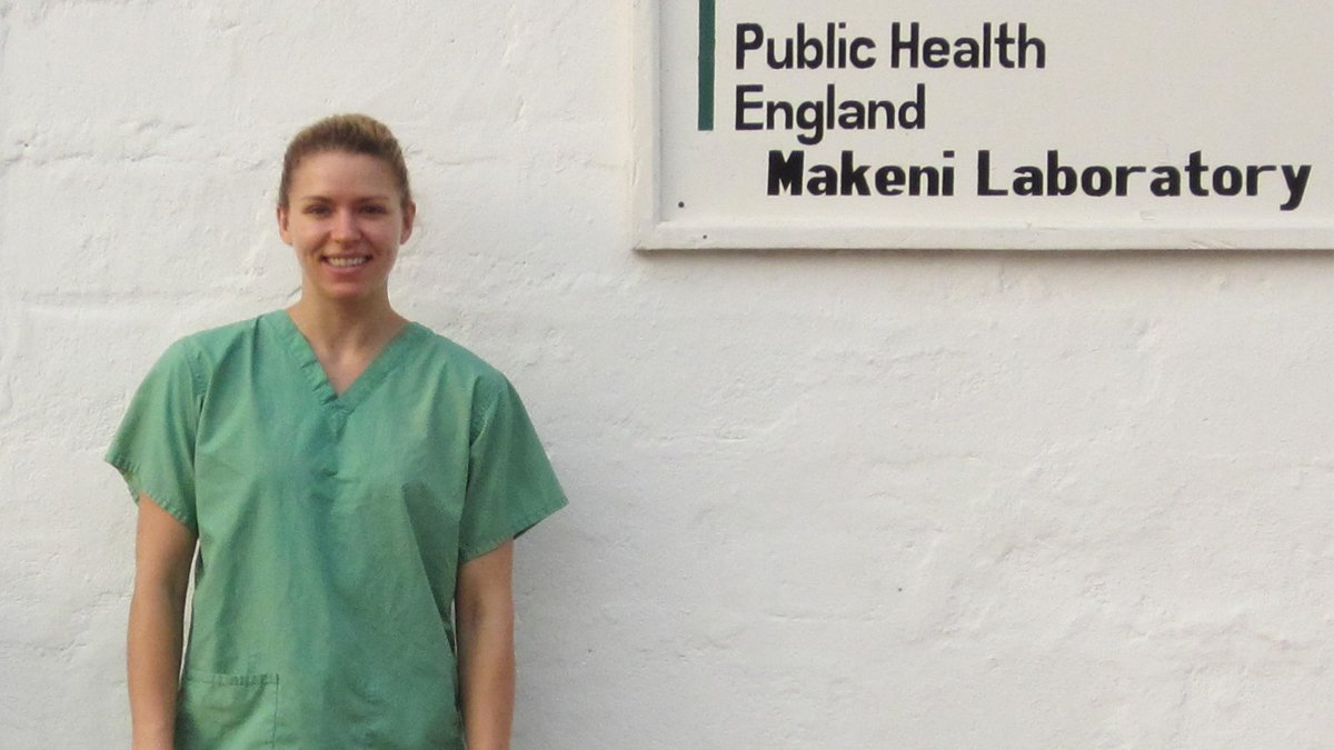 Emma Wise wearing scrubs outside the Makeni Laboratory