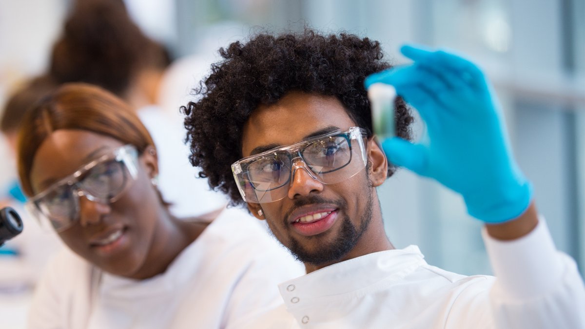 Student holding up vial of liquid