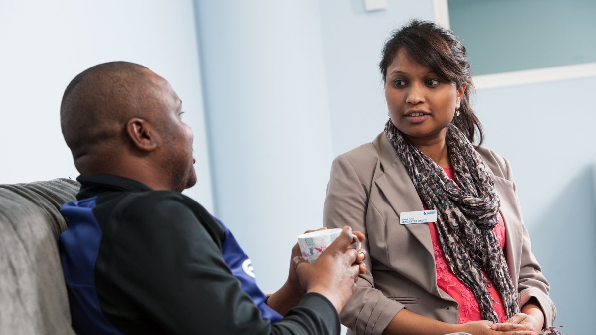 Nursing student talking to patient