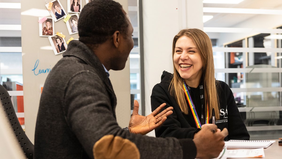 Two students talking in the Library