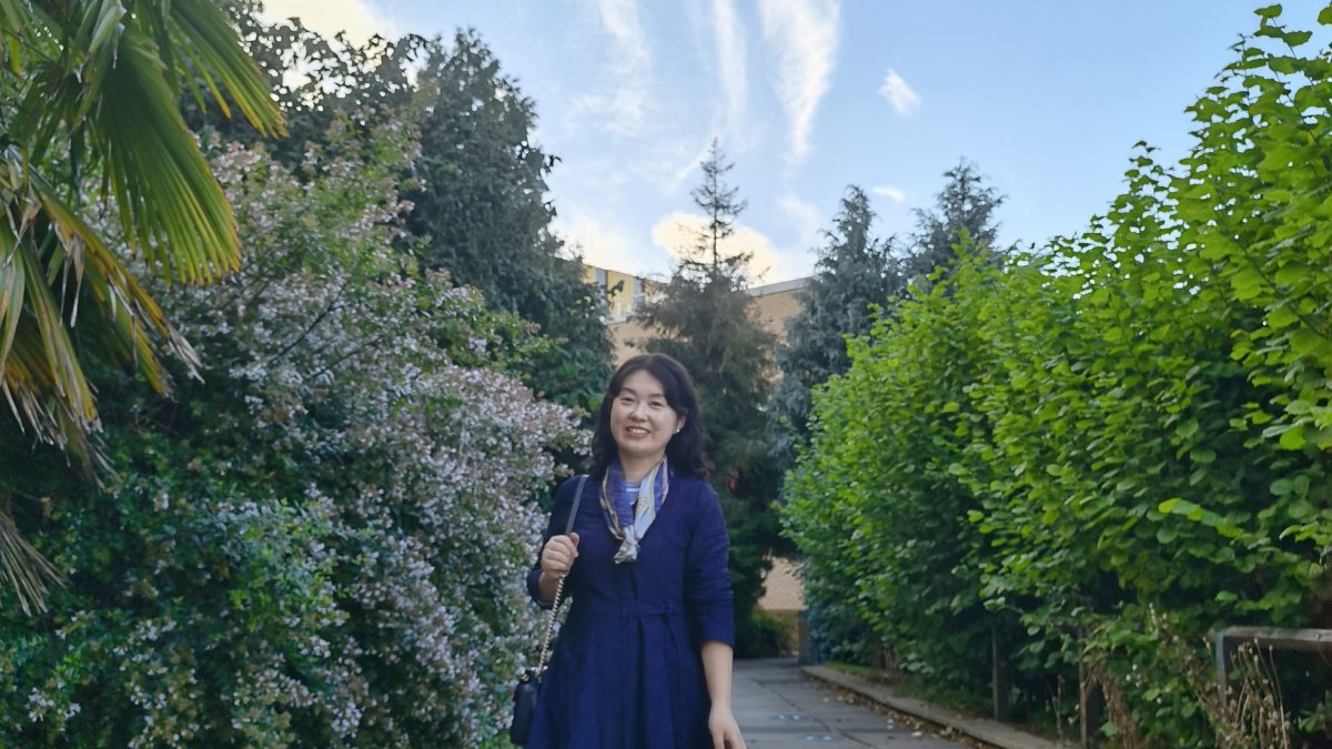 Higher Education PhD student Fengmei Zhu on University of Surrey campus