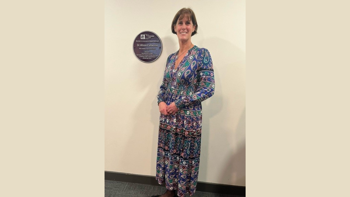 Dr Callwood in front of her Purple Plaque