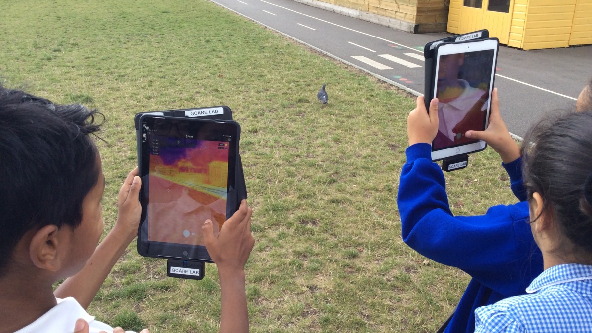 Children using thermal imaging technology on a tablet