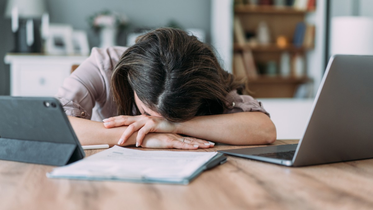 women stressed at work with head on desk